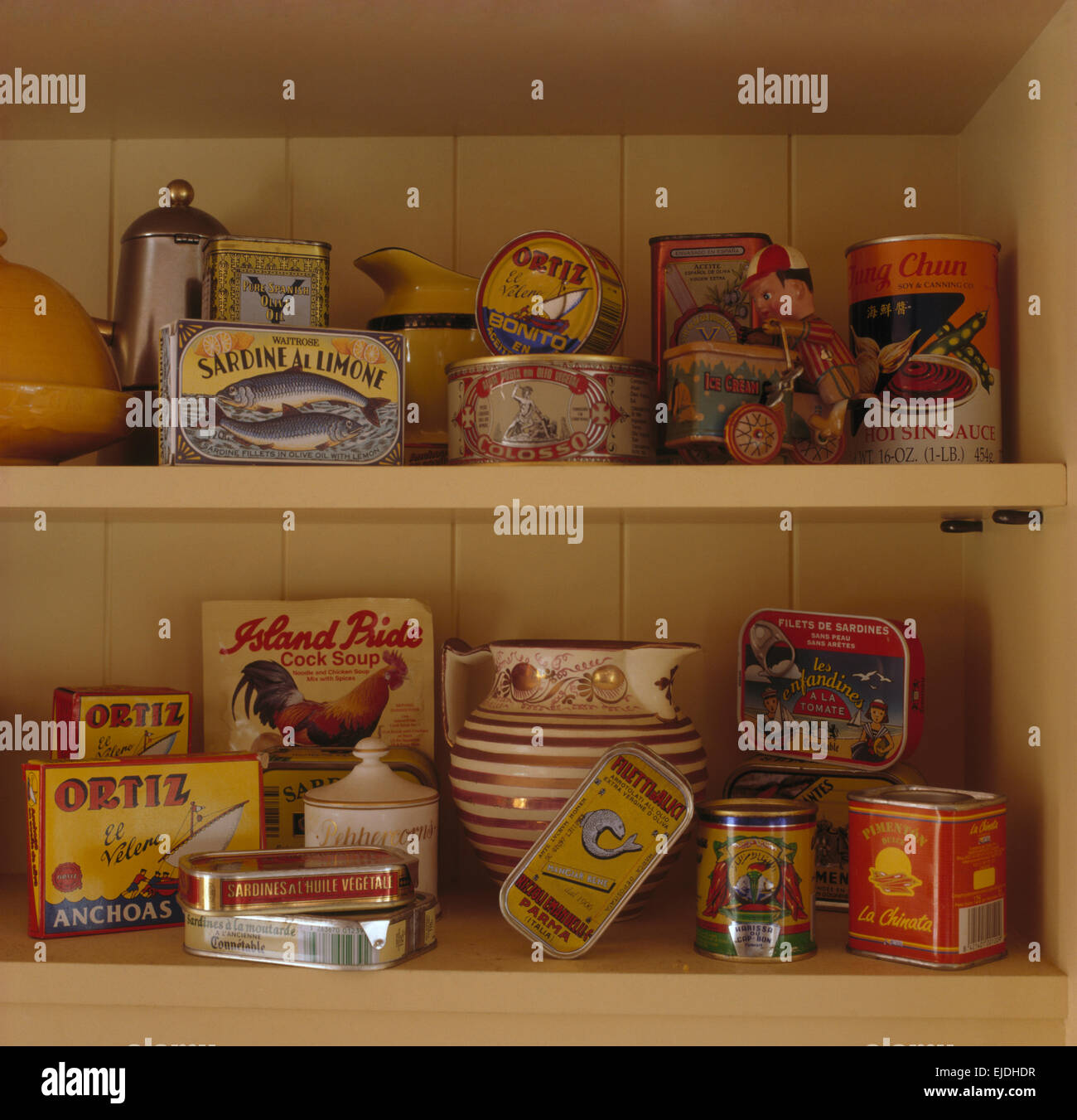 Close-up of a collection of vintage tins of food on shelves Stock Photo