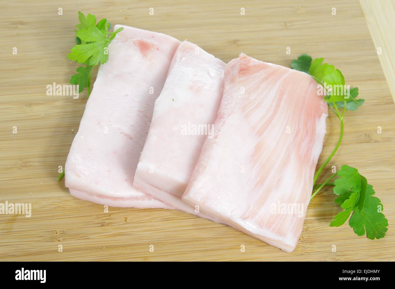 pork fat with parsley on board background Stock Photo