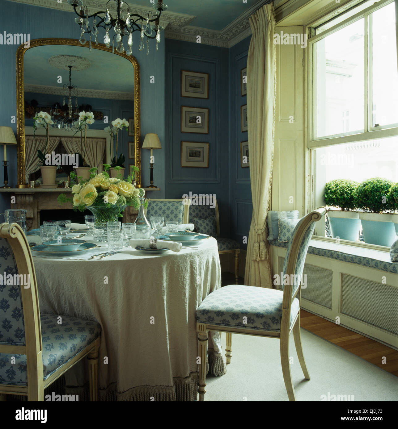 Patterned Upholstered Chairs At Table Set For Lunch With White