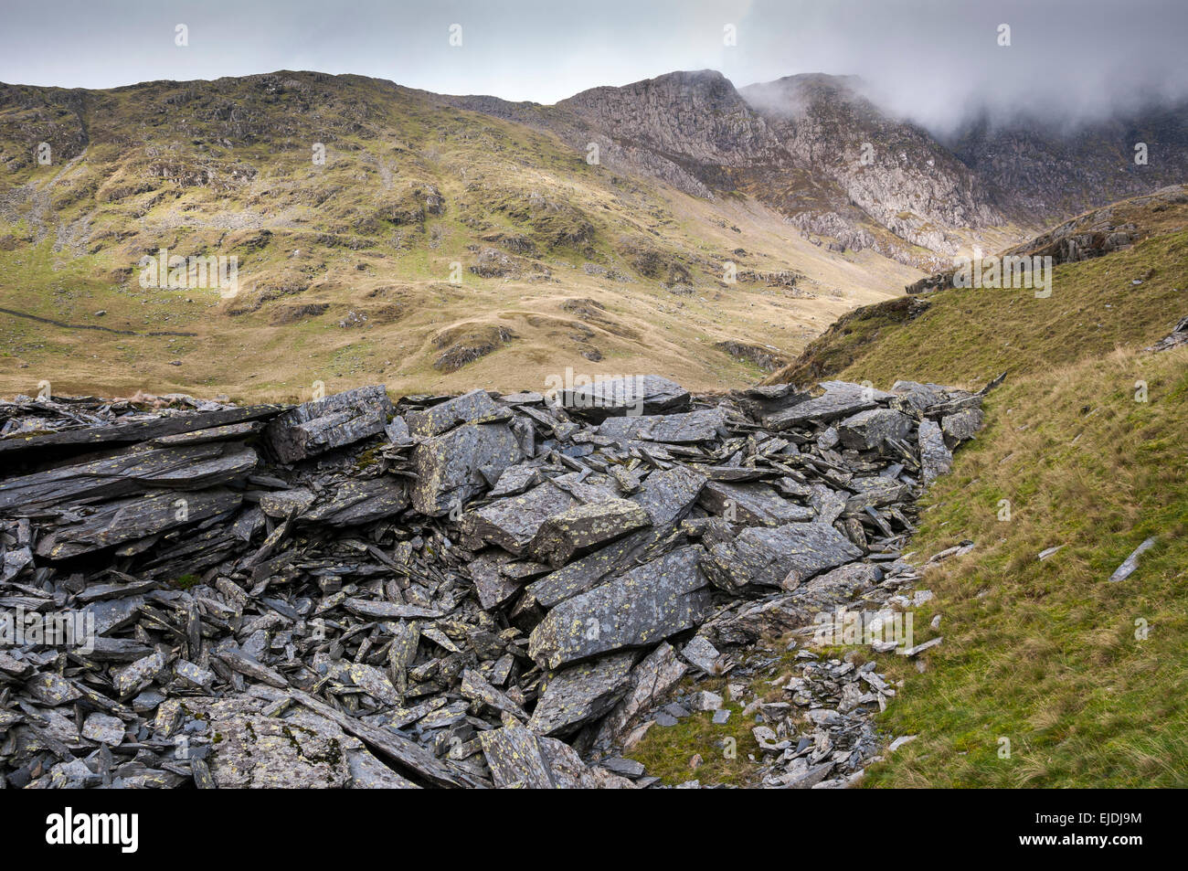 Heaps of rock at the disused quarries beside the Watkin Path near Snowdon, North Wales. Stock Photo