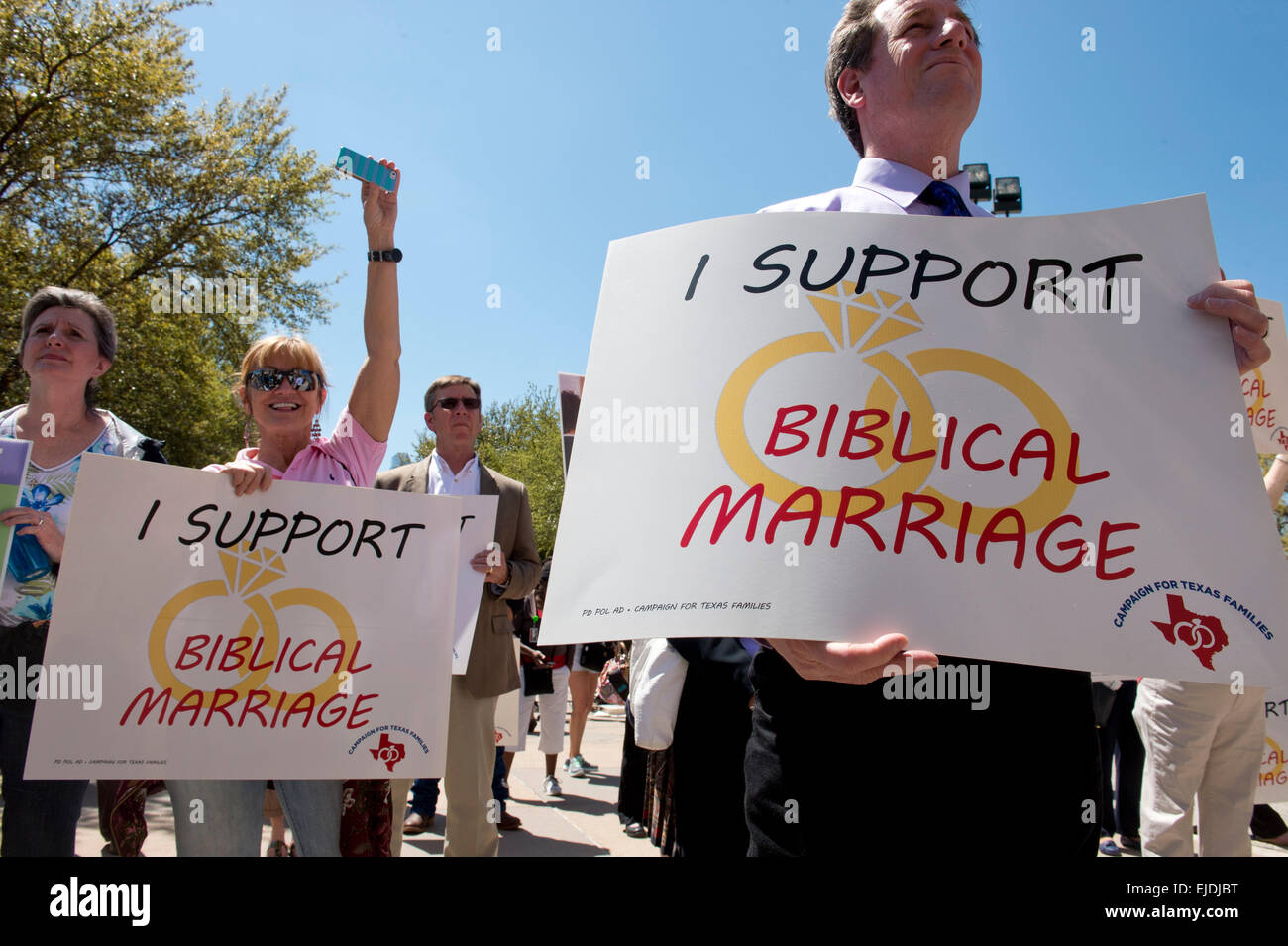 Austin, Texas, USA. 23rd March, 2015. Anti-gay marriage protesters hold signs as controversial  Alabama Supreme Court Chief Justice Roy Moore speaks at a rally of conservative Texas legislators opposing gay marriage at a Texas Capitol rally Monday.  Moore has told Alabama judges to ignore a recent federal court ruling allowing gay marriage in the state. Credit:  Bob Daemmrich/Alamy Live News Stock Photo