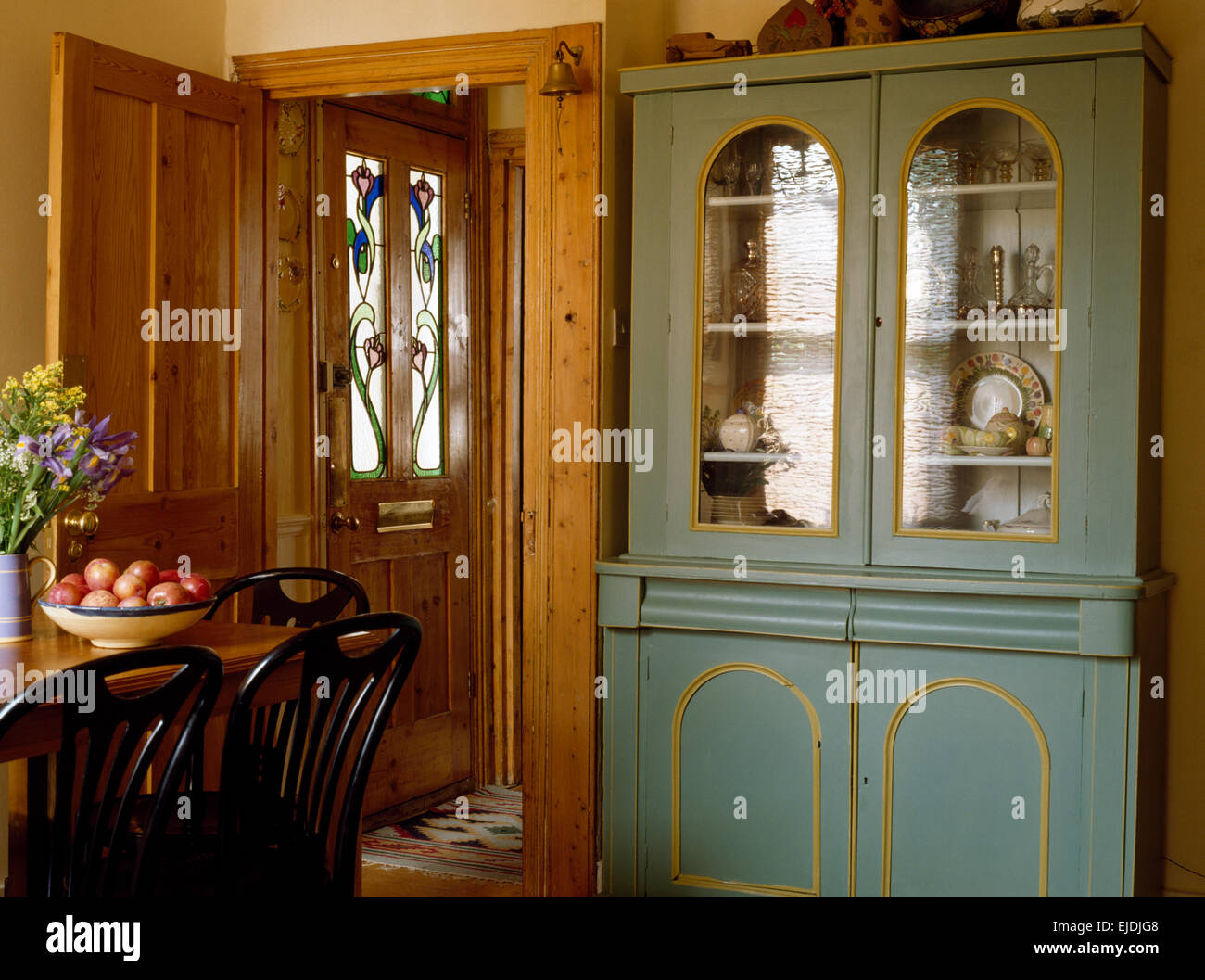 Painted Glass Front Dresser In An Nineties Dining Room Stock Photo