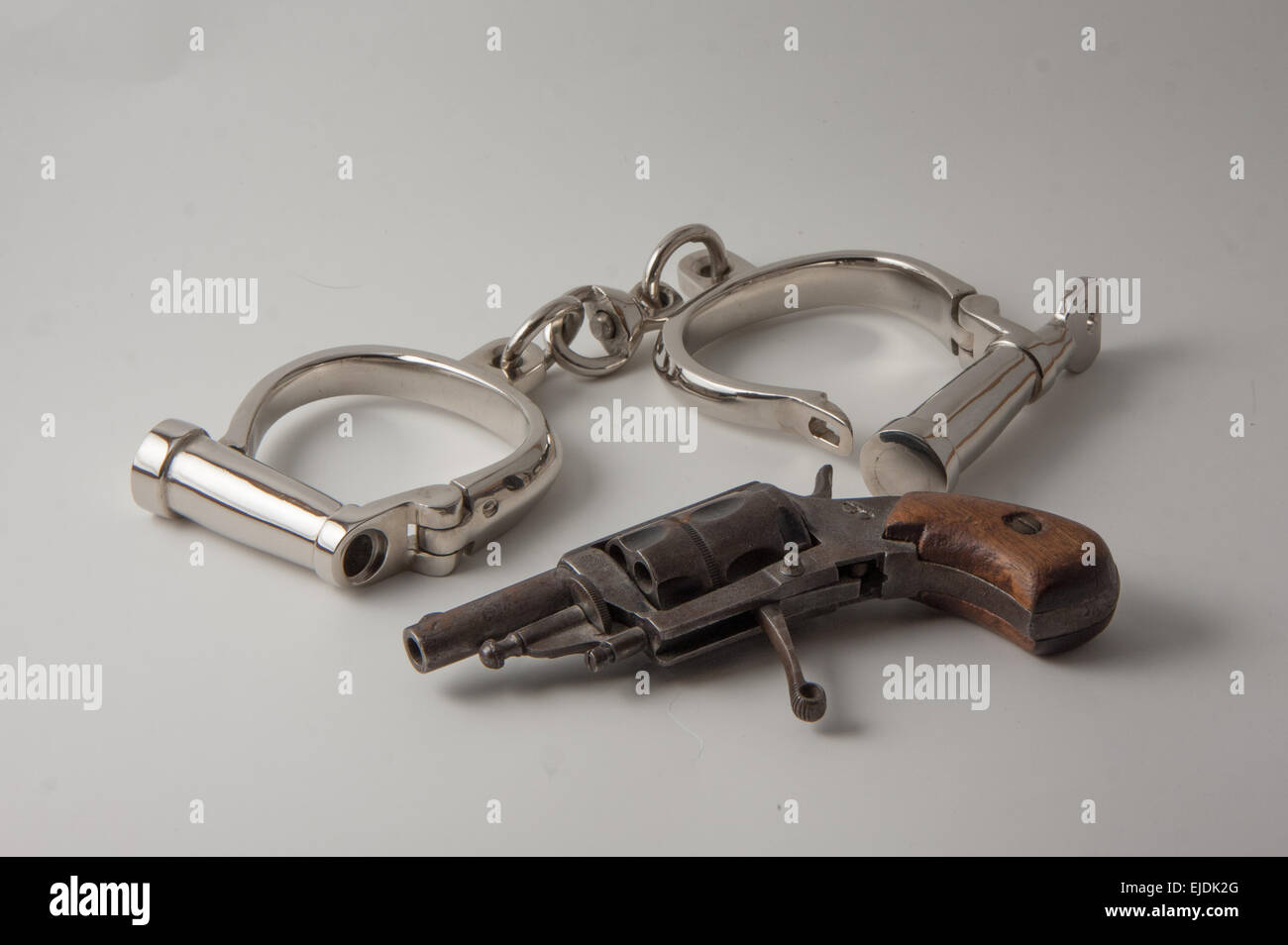 old handcuffs with locking screw English style and revolver derringer
