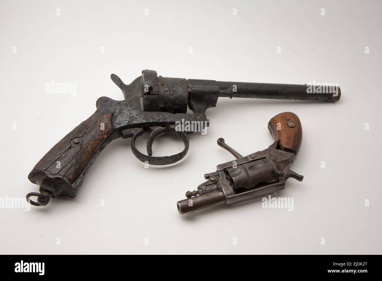 old revolver style derringer and colt rusty and damage Stock Photo