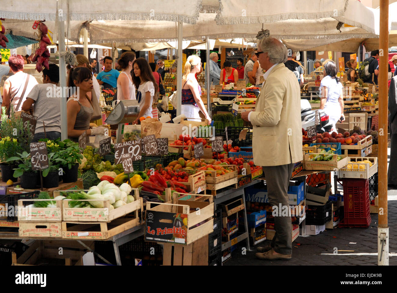 Shopper and stallholder in the market at Campo de' Fiore, Rome. Stock Photo