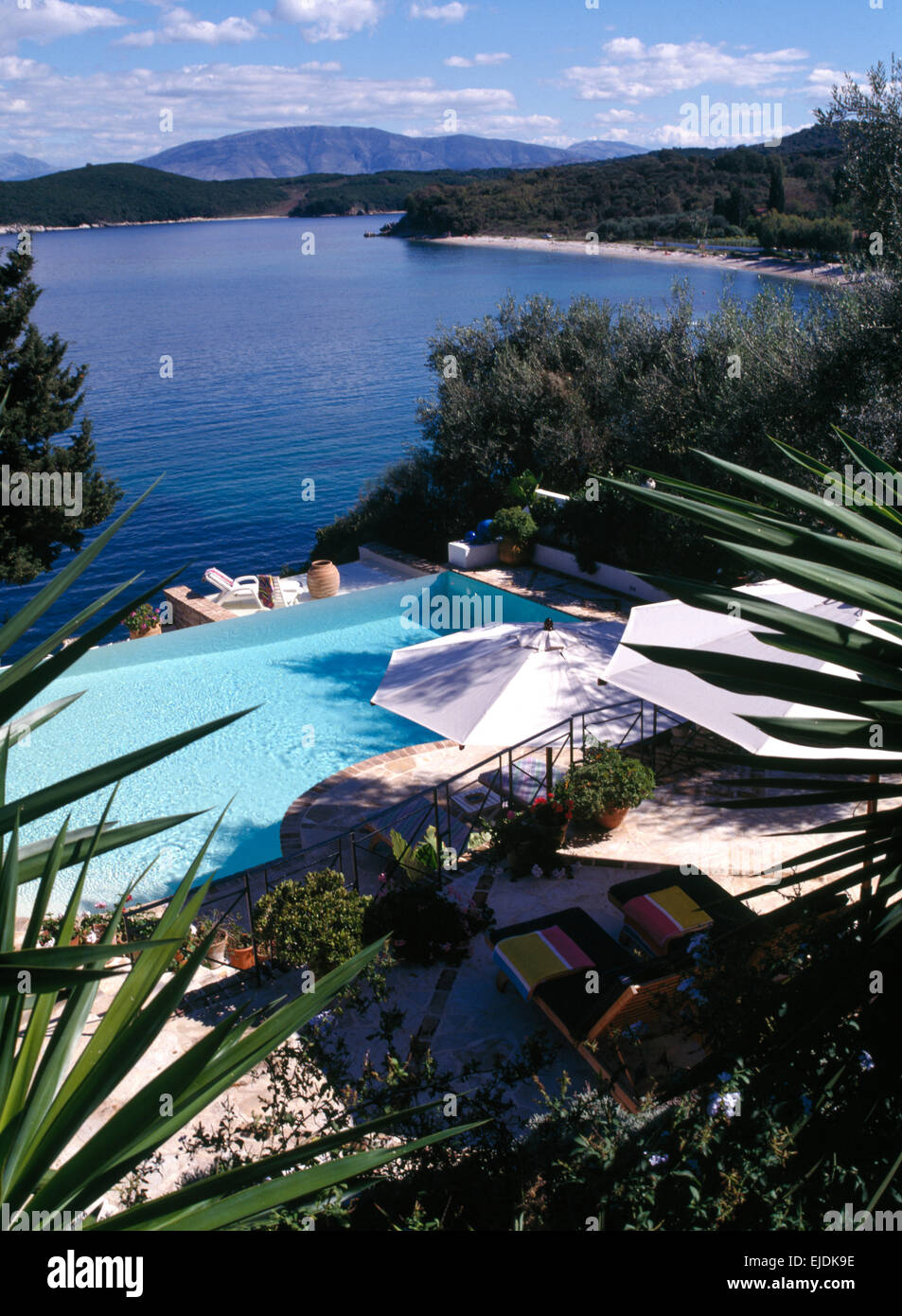 Birds-eye view of patio and swimming pool in hillside garden above the ocean on the island of Corfu Stock Photo