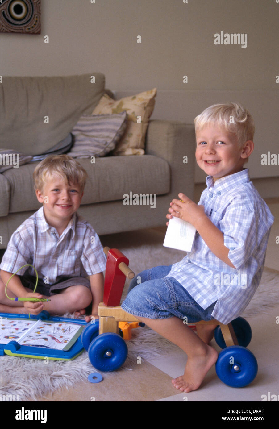 Portrait of two small boys playing in living room       FOR EDITORIAL USE ONLY Stock Photo