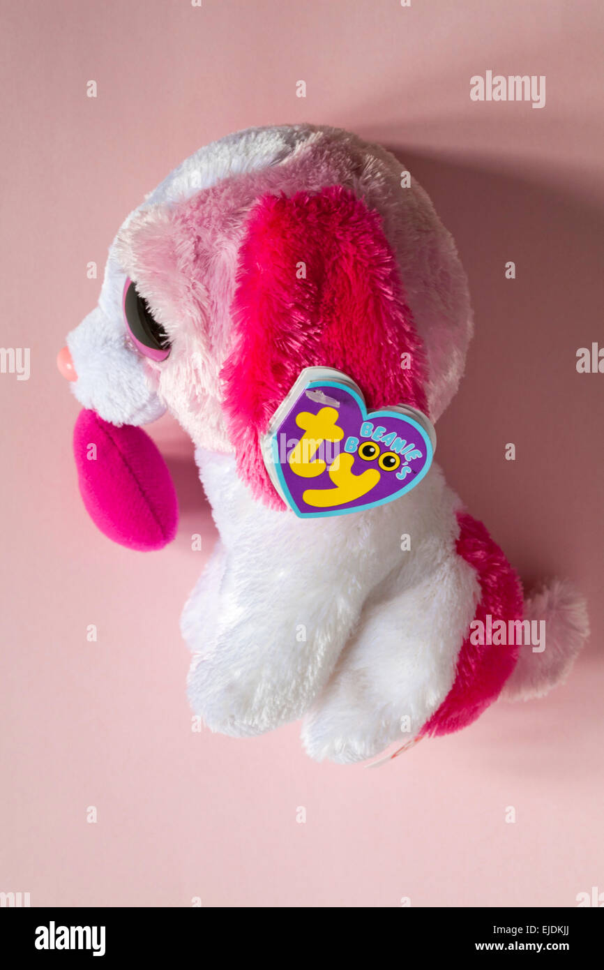 ty beanie boo's label tag on soft cuddly toy dog puppy cookie dog with heart isolated on pink background Stock Photo
