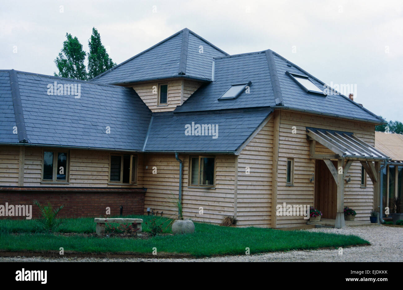 New Build Clapboard House With Porch And Dormer Windows And Slate