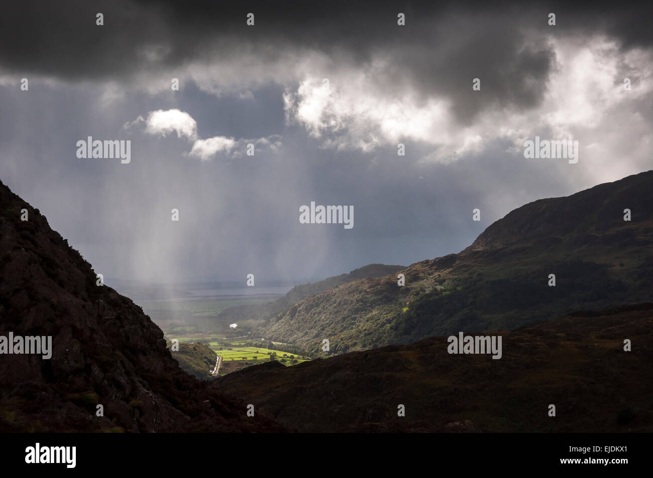 Dramatic lighting near Bedggelert in Snowdonia, North Wales. Sunbeams break through the low cloud. Stock Photo