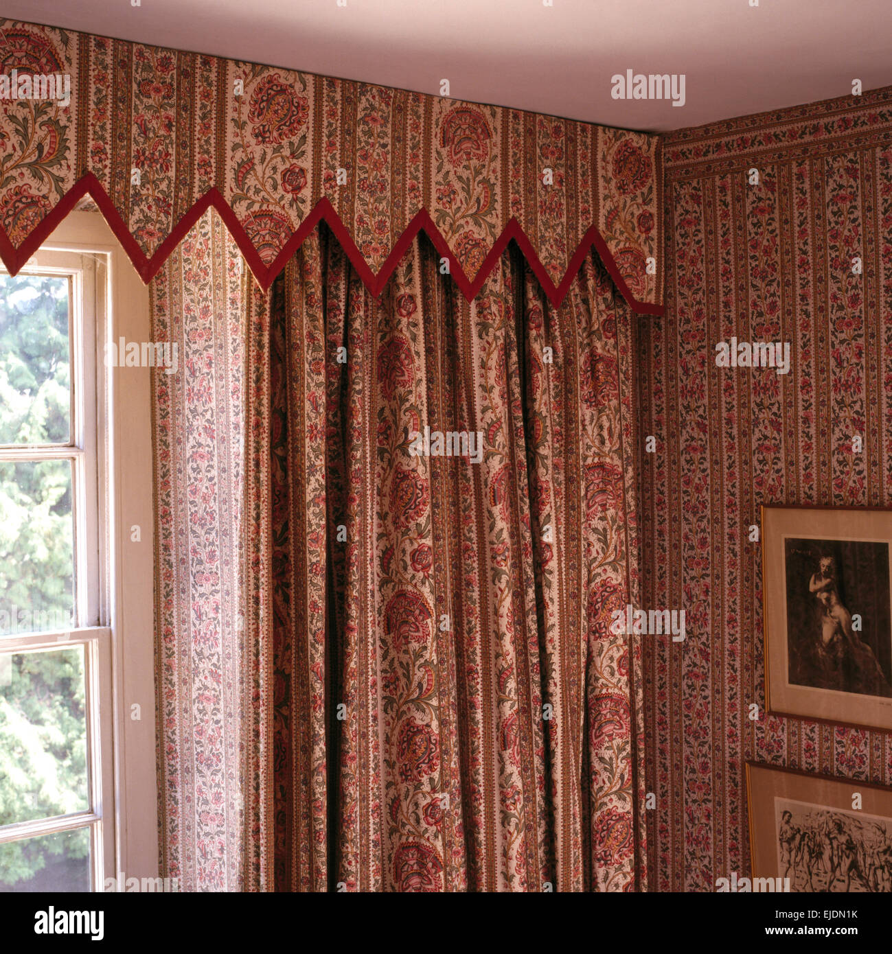 Close-up of patterned curtains and matching Gothic style pelmet and wallpaper designed by Henrietta Spencer-Churchill Stock Photo