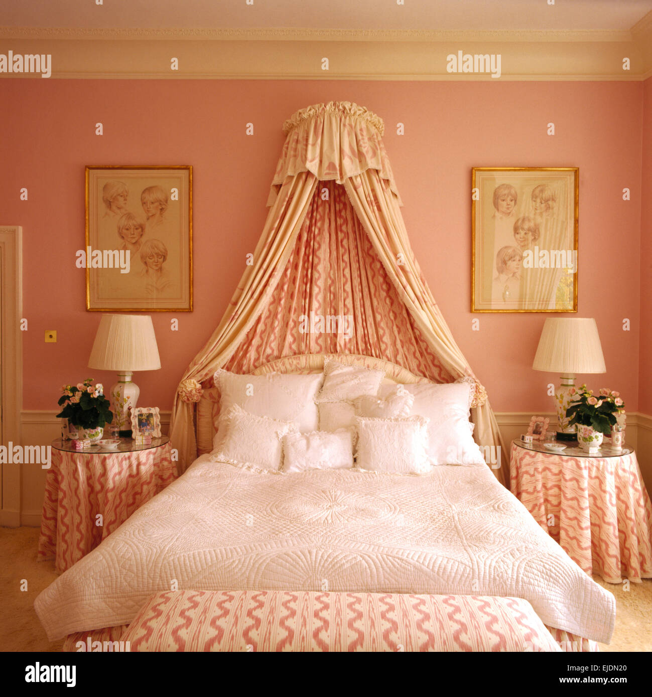 Coronet And Drapes Above Bed With White Quilt And Cushions In Pink