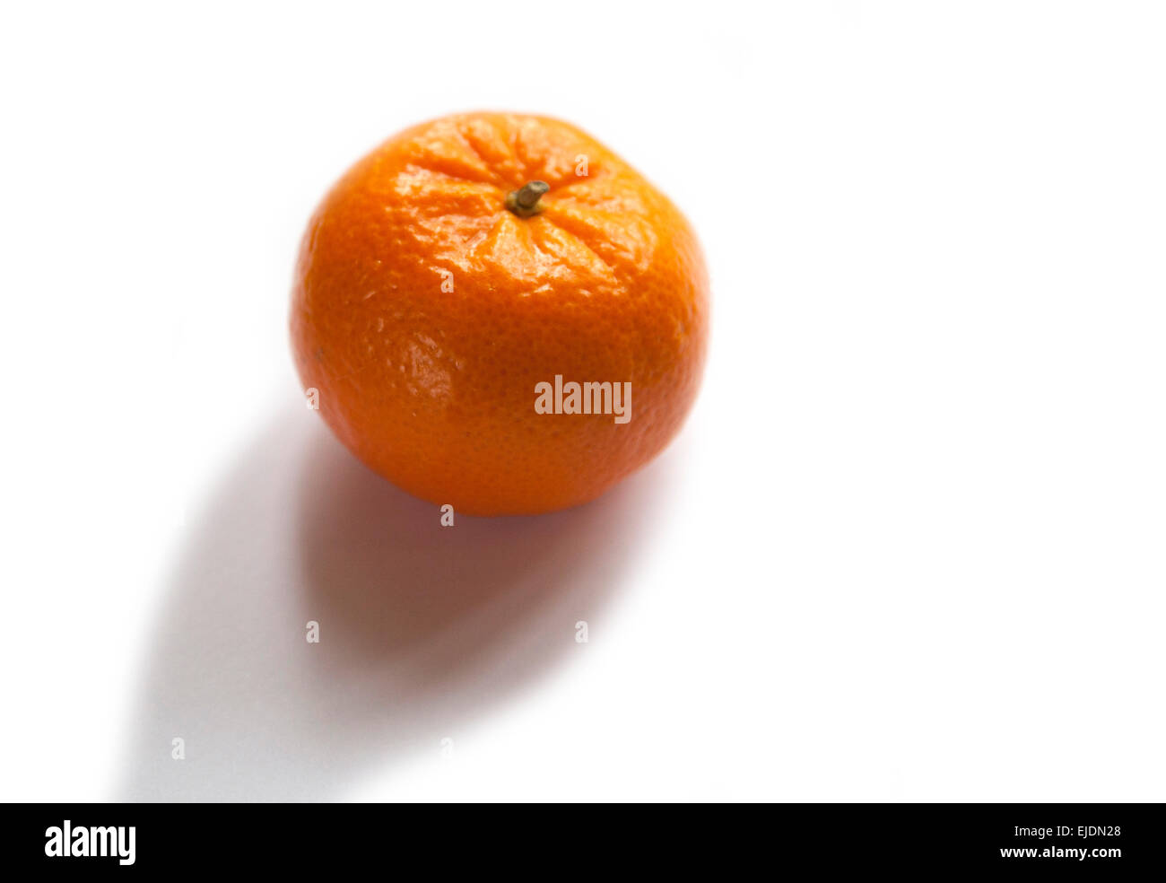 a fresh entire Orange fruit on a white background with a small shadow underneath Stock Photo