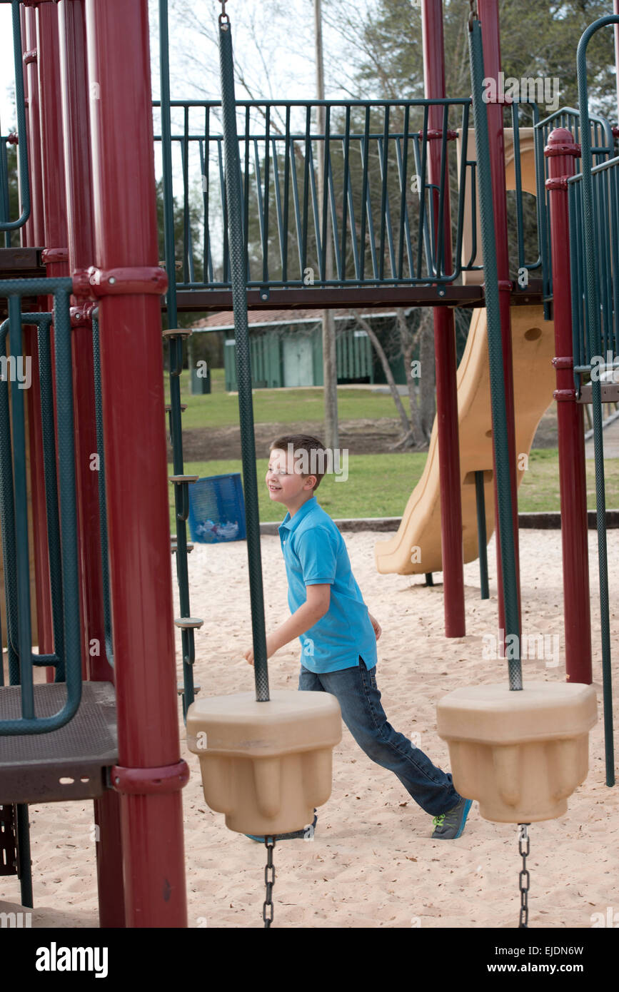 Young boy plays at park playground Stock Photo