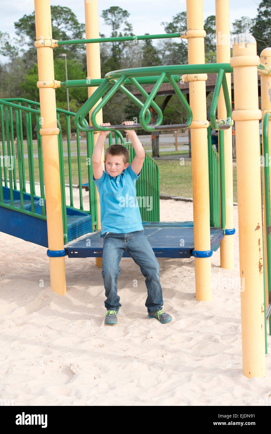 Young boy plays at park playground Stock Photo