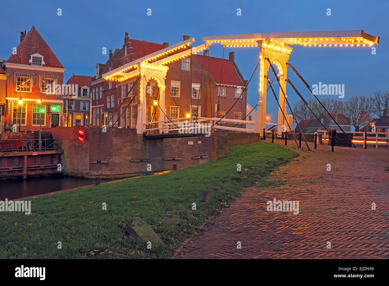 Medieval bridge and houses in the village Enkhuizen The Netherlands by twilight Stock Photo