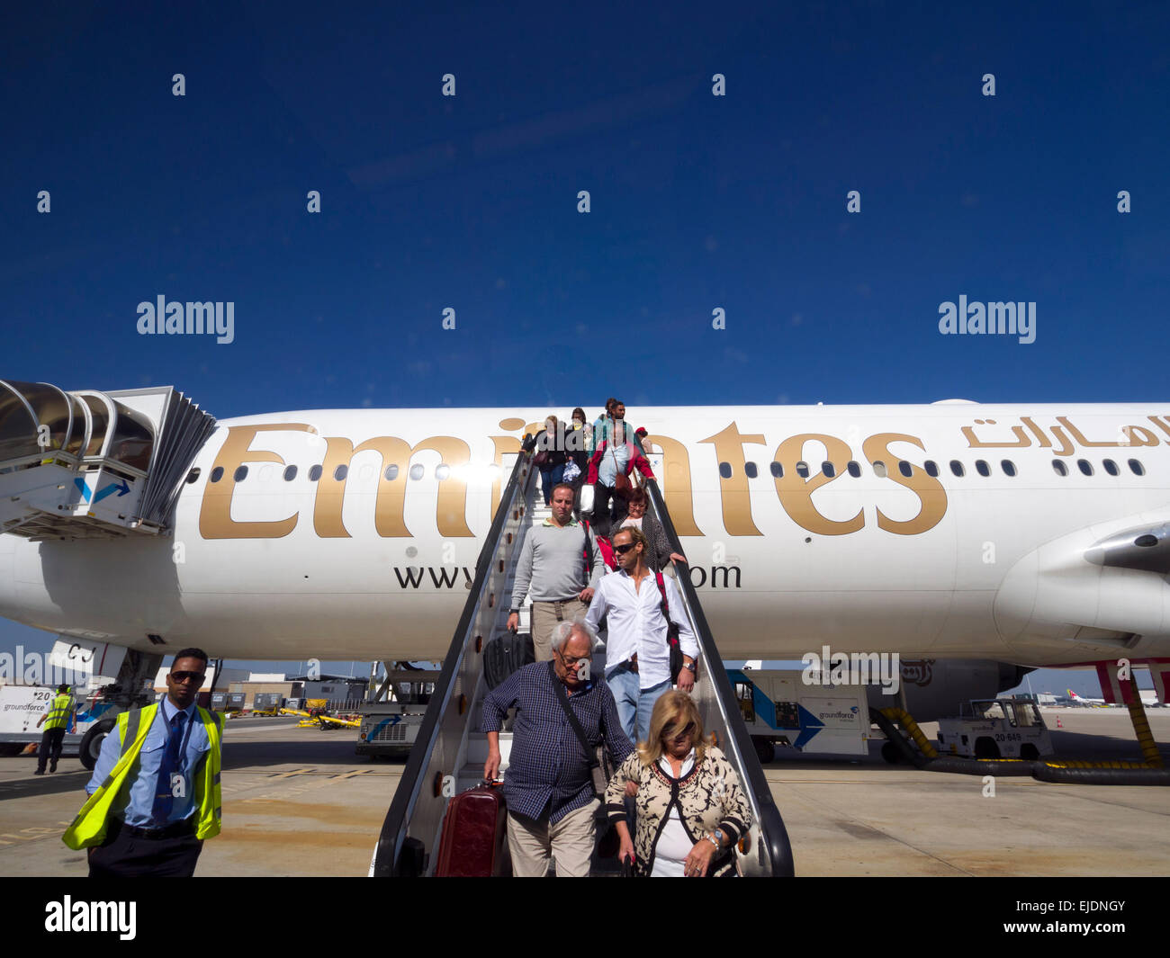 Passengers disembarking an Emirates airplane Stock Photo