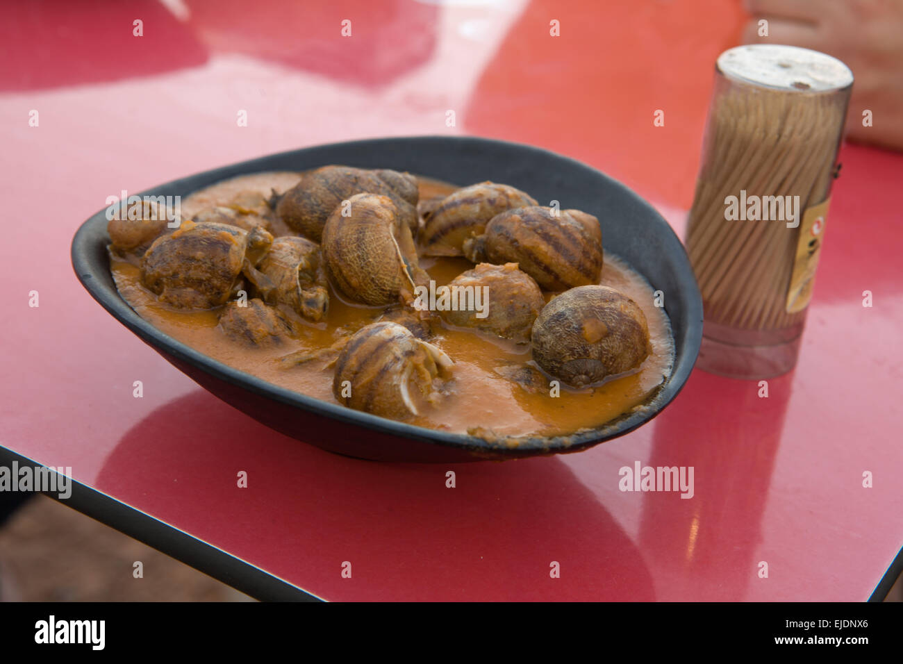 Snails with red tomato spicy souce, Cordoba, Spain Stock Photo