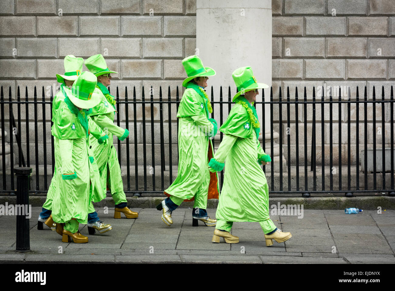 St Patrick's Day Dublin 2015 - 5 men in glam Irish outfits and platforms walk along street Stock Photo
