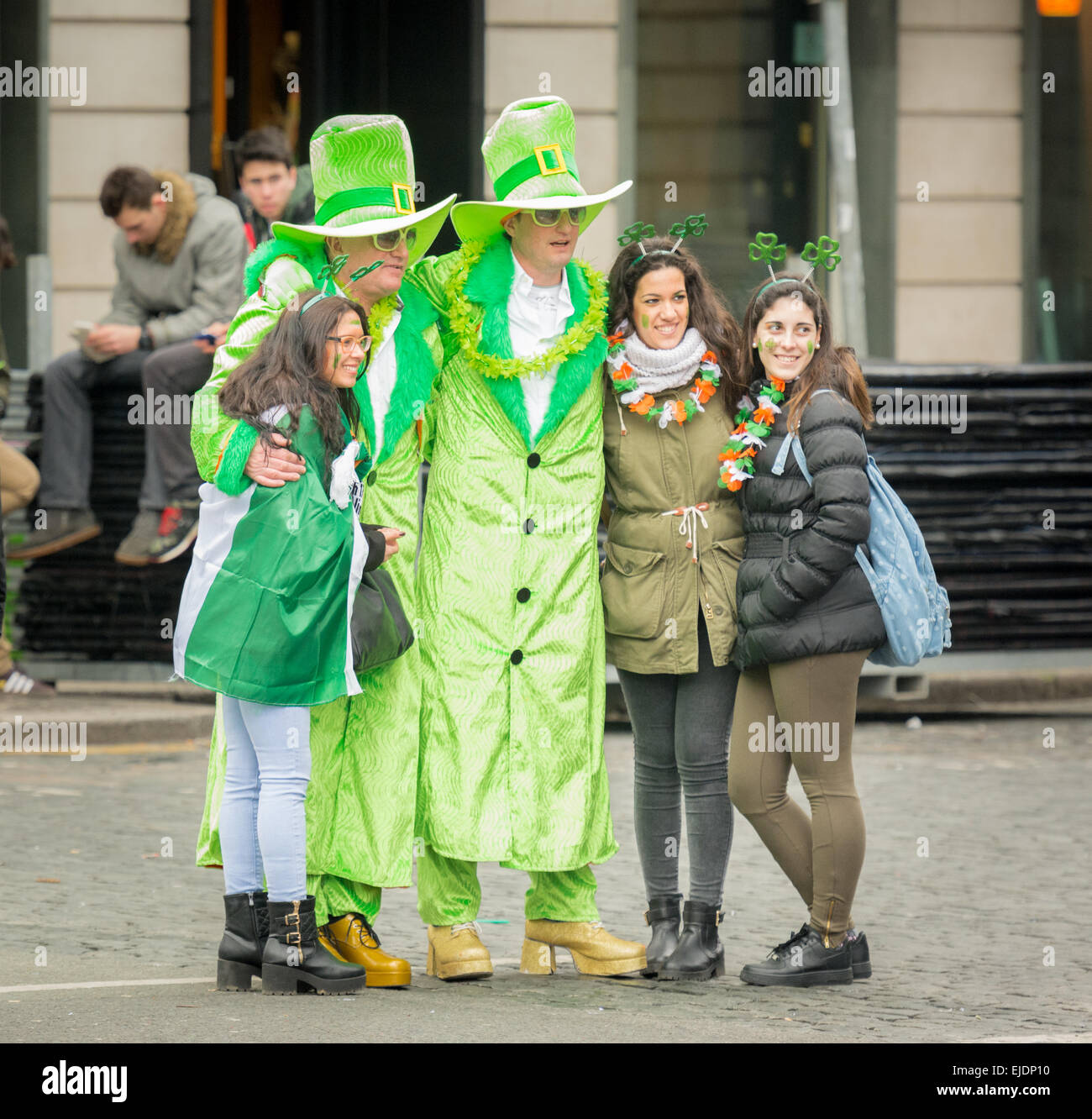 Revellers dressed in green glam outfits celebrating St Patrick's Day 2015 in Dublin with some visiting European tourists Stock Photo