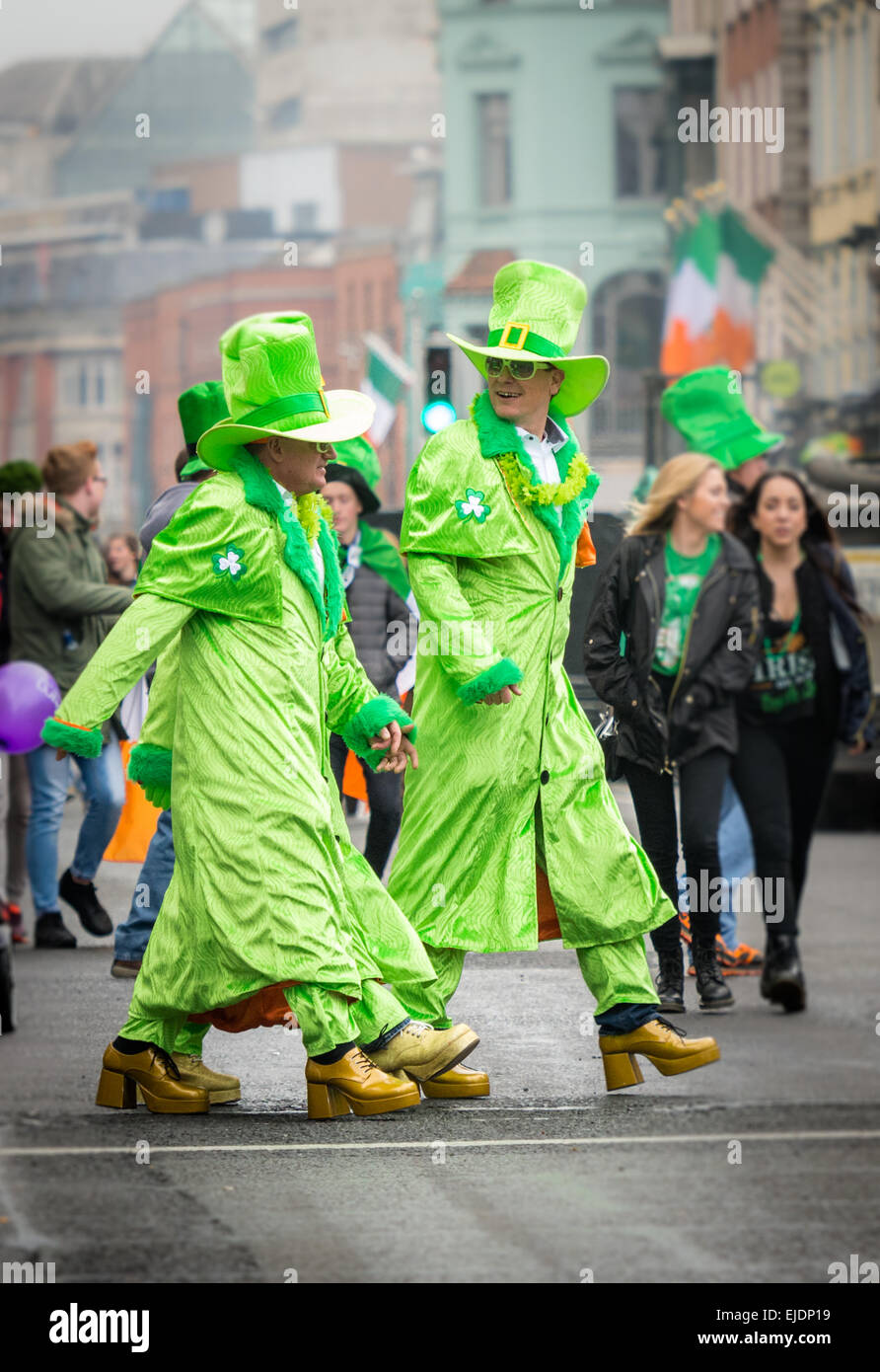 Revellers dressed in green glam outfits celebrating St Patrick's Day 2015 in Dublin Stock Photo