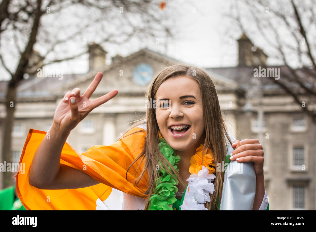 Smiling teenage Irish girl celebrating St Patrick's Day in Dublin outside Trinity College Stock Photo