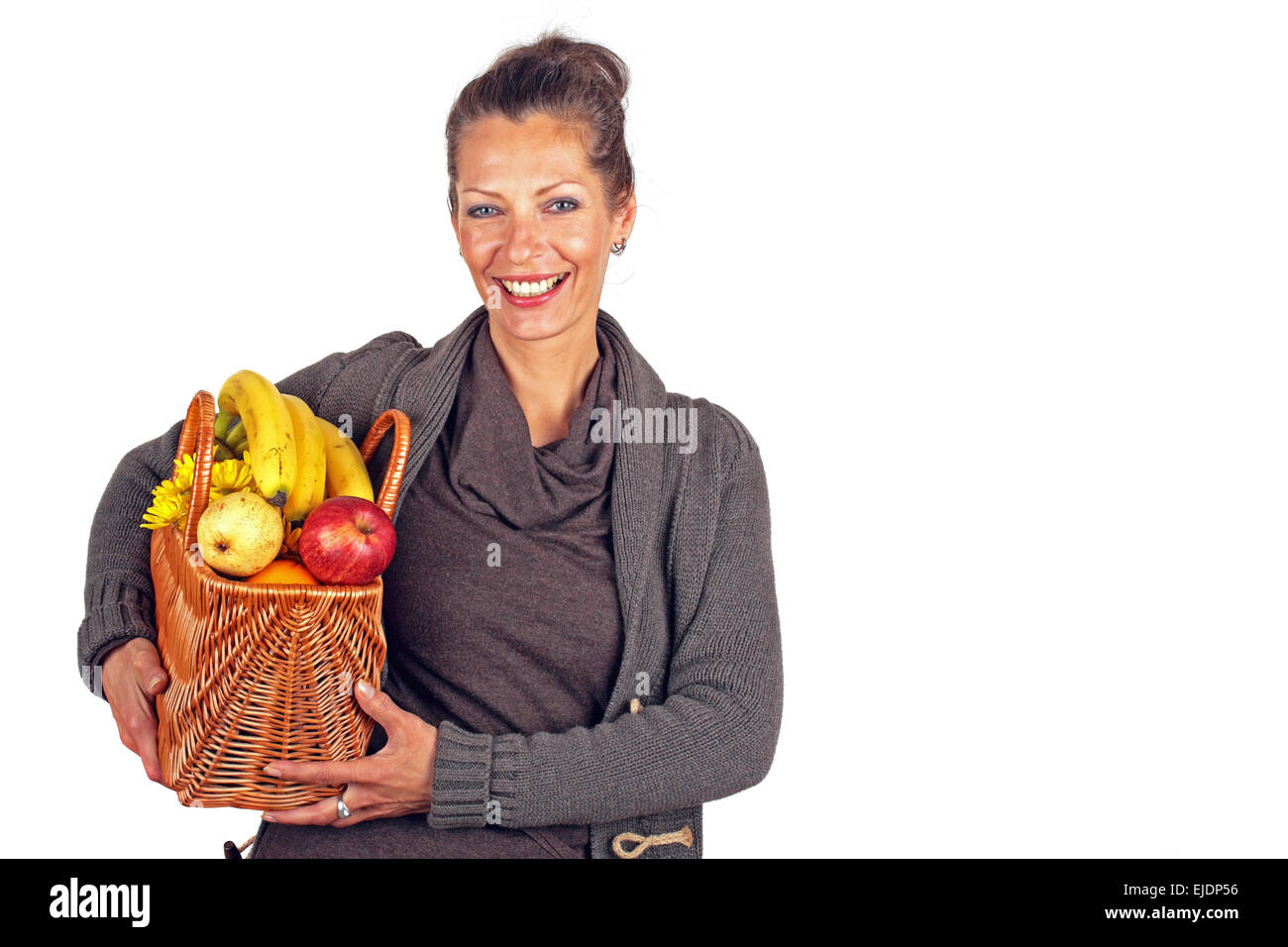 Beautiful woman with a basket full of fruits and flowers Stock Photo ...