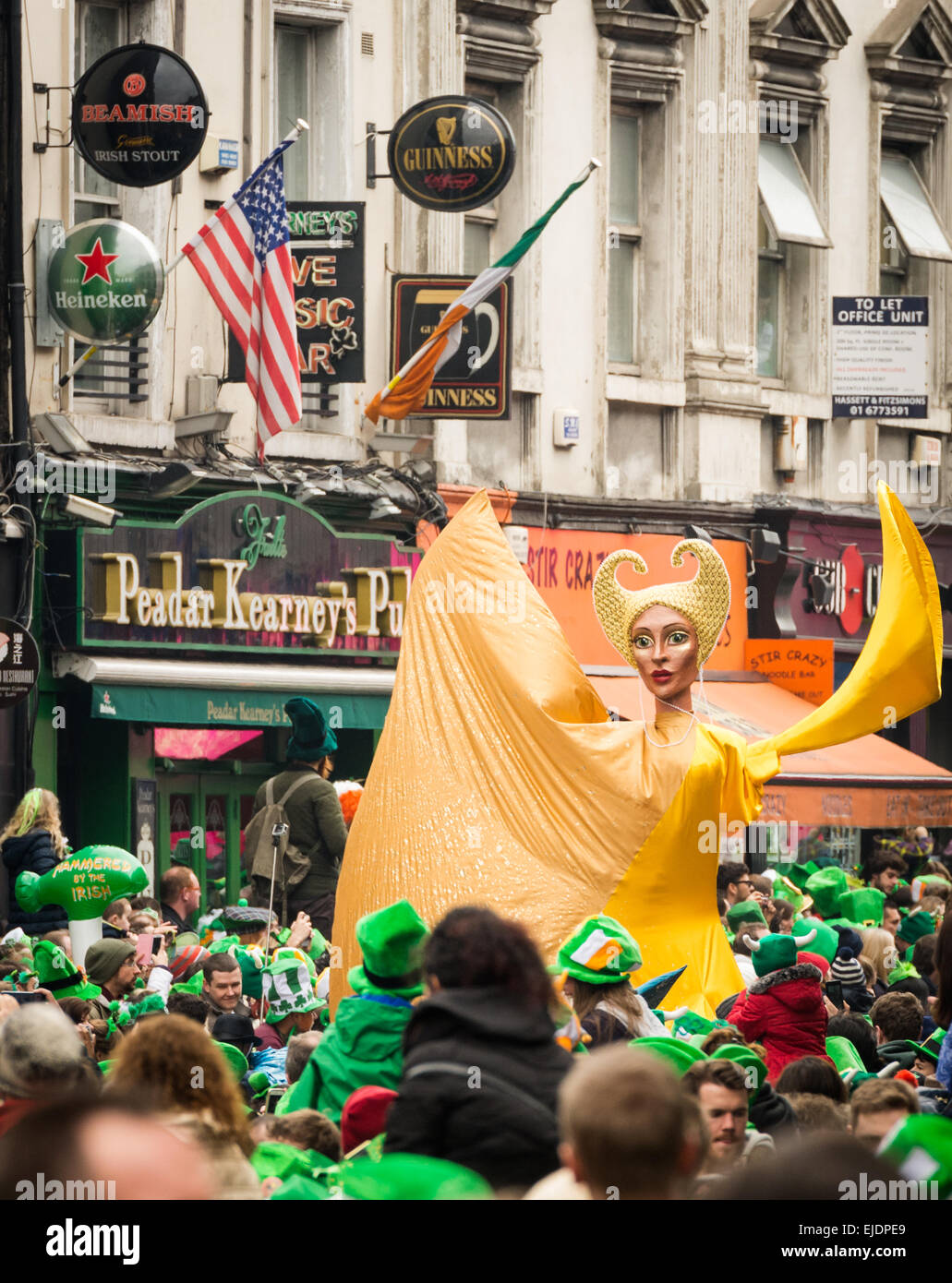 Giant Puppet surrounded by festival goers in green at St Patrick's Day Parade in Dublin's Dame Street 2015 Stock Photo