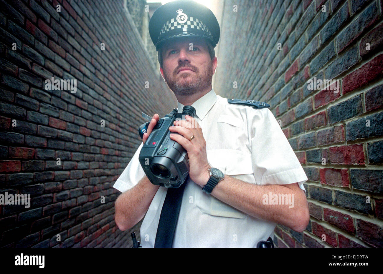 Sergeant Allan Penfold, from Haywards Heath police station, using a camcorder to gather evidence. Stock Photo