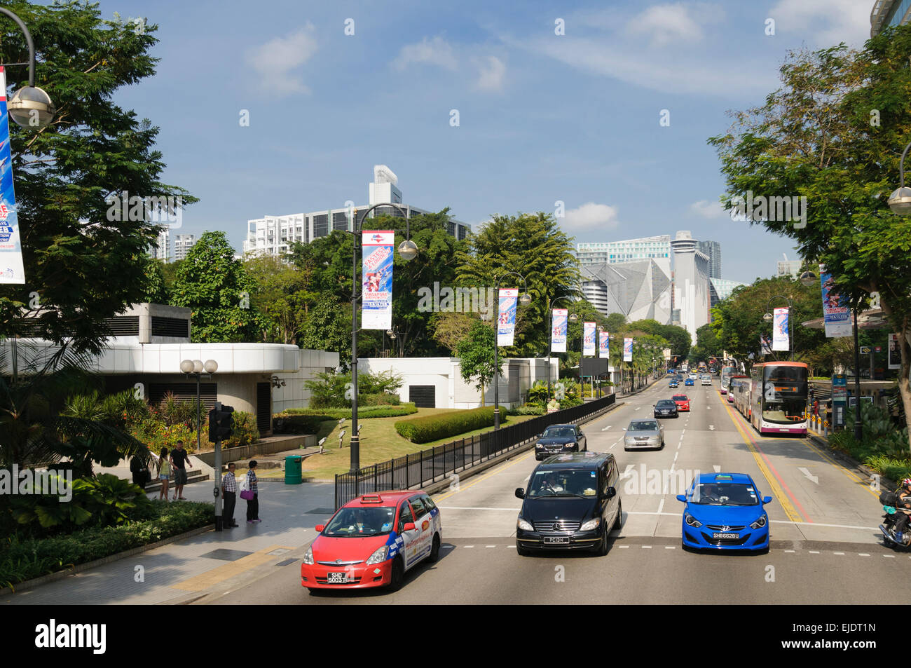 Traffic at the eastern end of Orchard Road, Singapore. Dhoby Ghaut MRT Station on the left. Stock Photo
