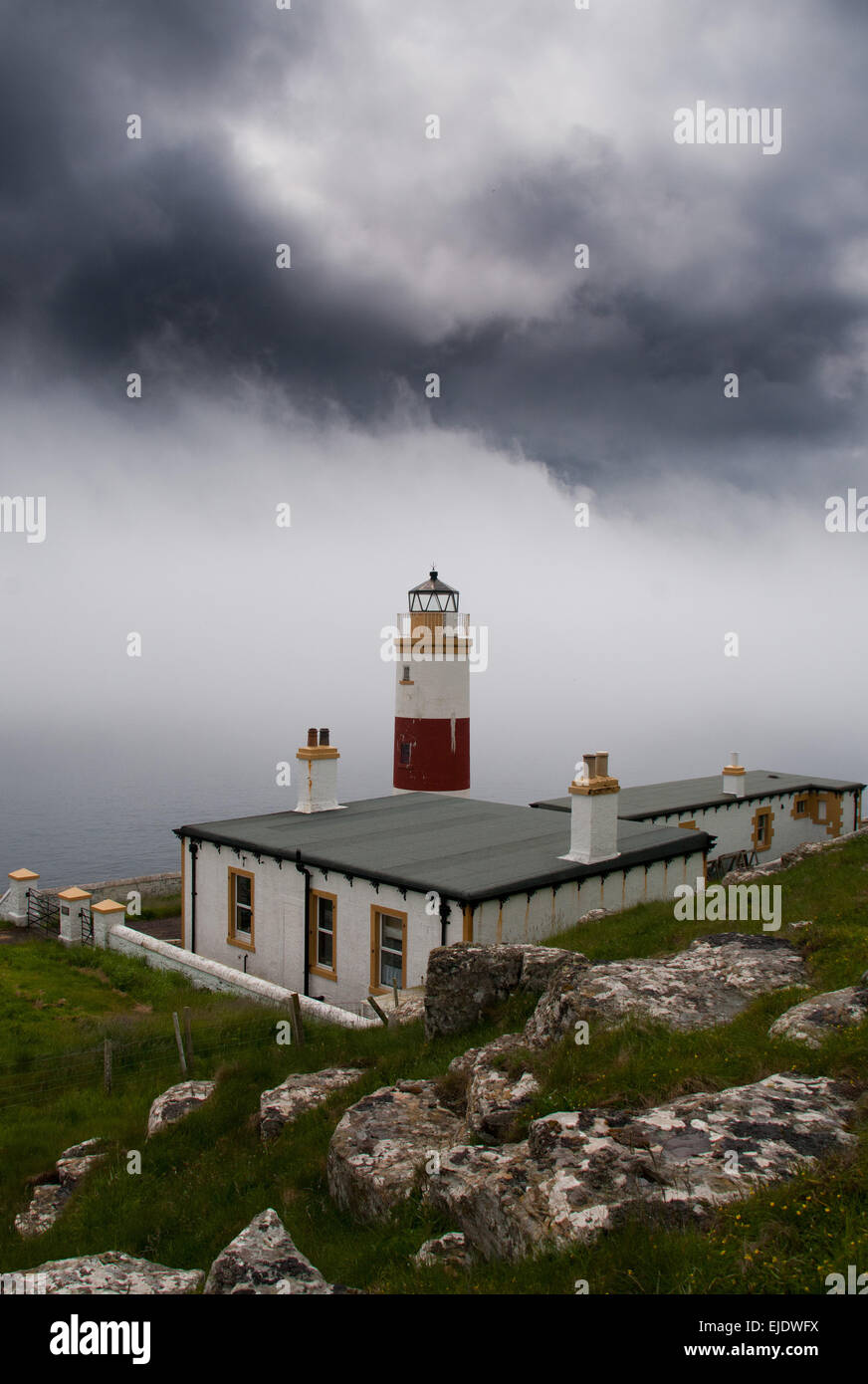 Clyth Ness lighthouse on the north east coast of Scotland, sea fog or haar rolling in from the North Sea. Stock Photo
