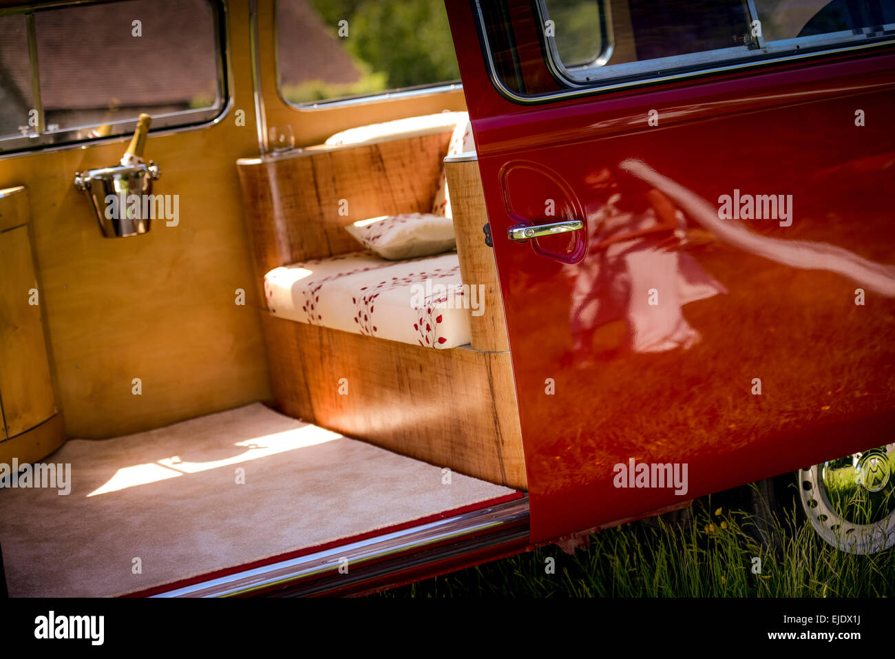A bright red VW camper bus prepared for a wedding. Stock Photo