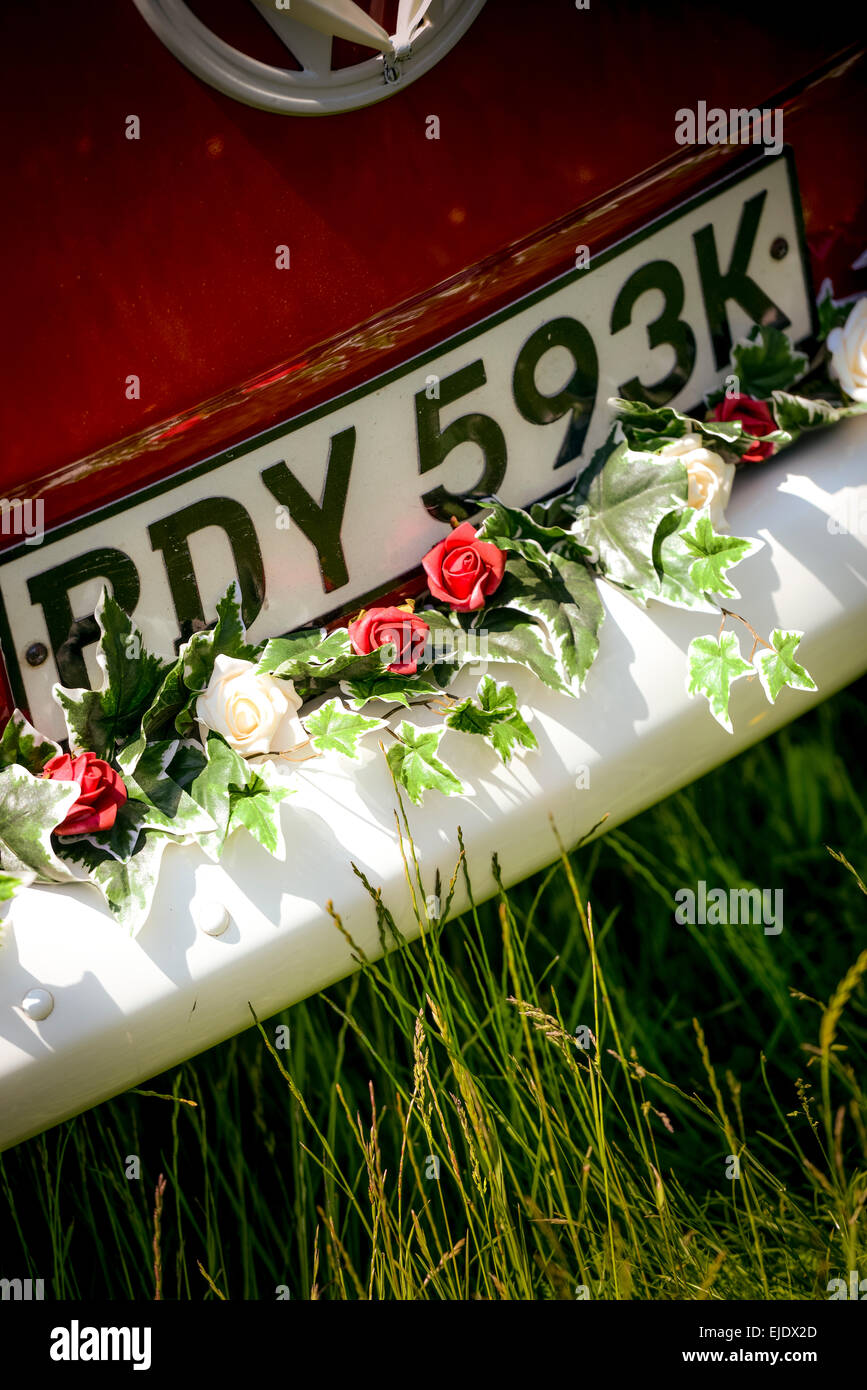 A bright red VW camper bus prepared for a wedding. Stock Photo