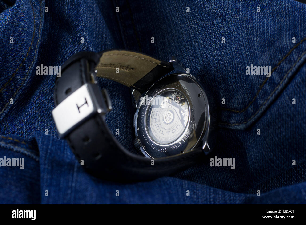 Photo shooting of elegant and luxury male wristwatches on denim background: Hamilton Jazz master wristwatch Stock Photo