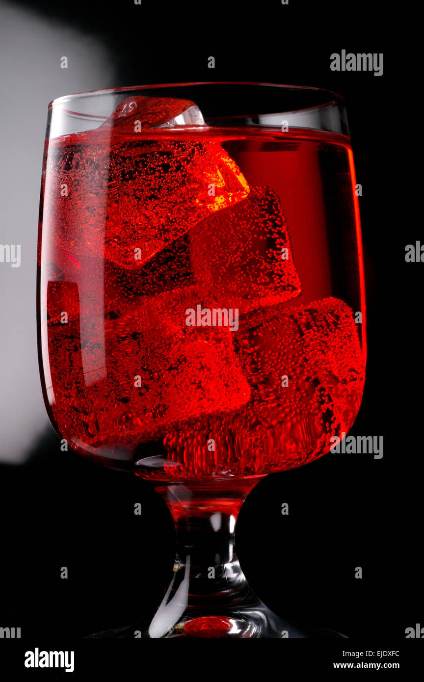Glass of red drink with ice closeup Stock Photo