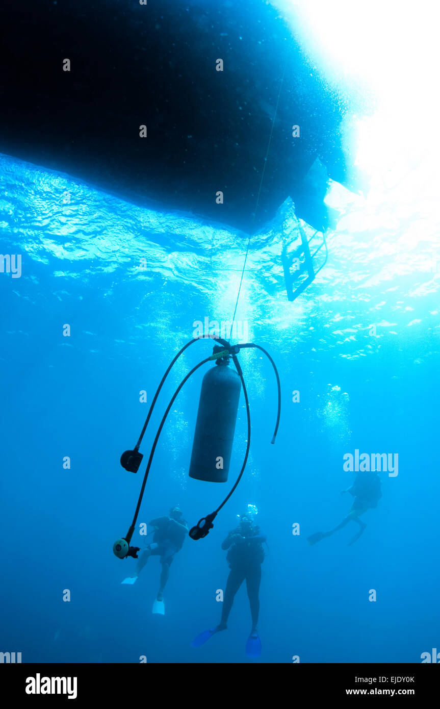 Scuba tank hanging underwater for divers making a safety stop after a