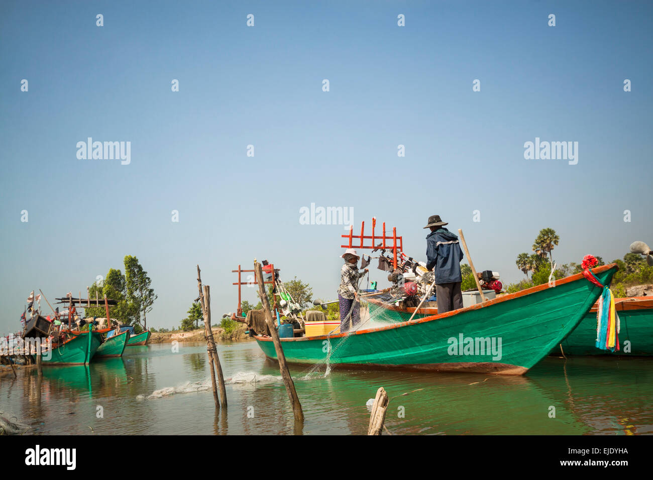 Fishing activities in Cambodia, Asia. Family pulling fishing net from the river hear Kep, Kep province. Stock Photo