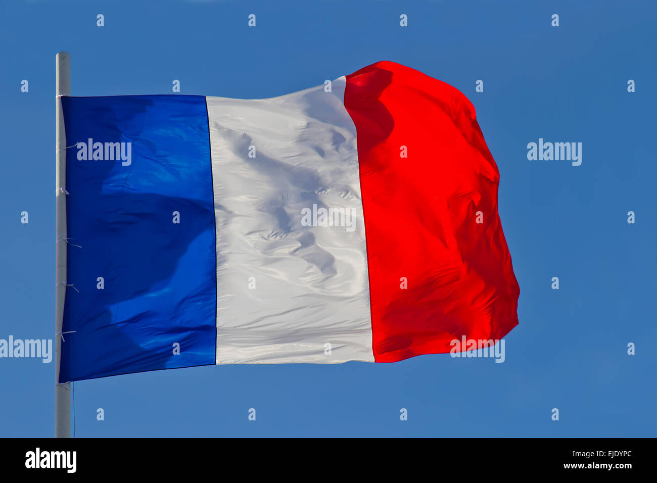 France flag is waving in front of blue sky Stock Photo Alamy