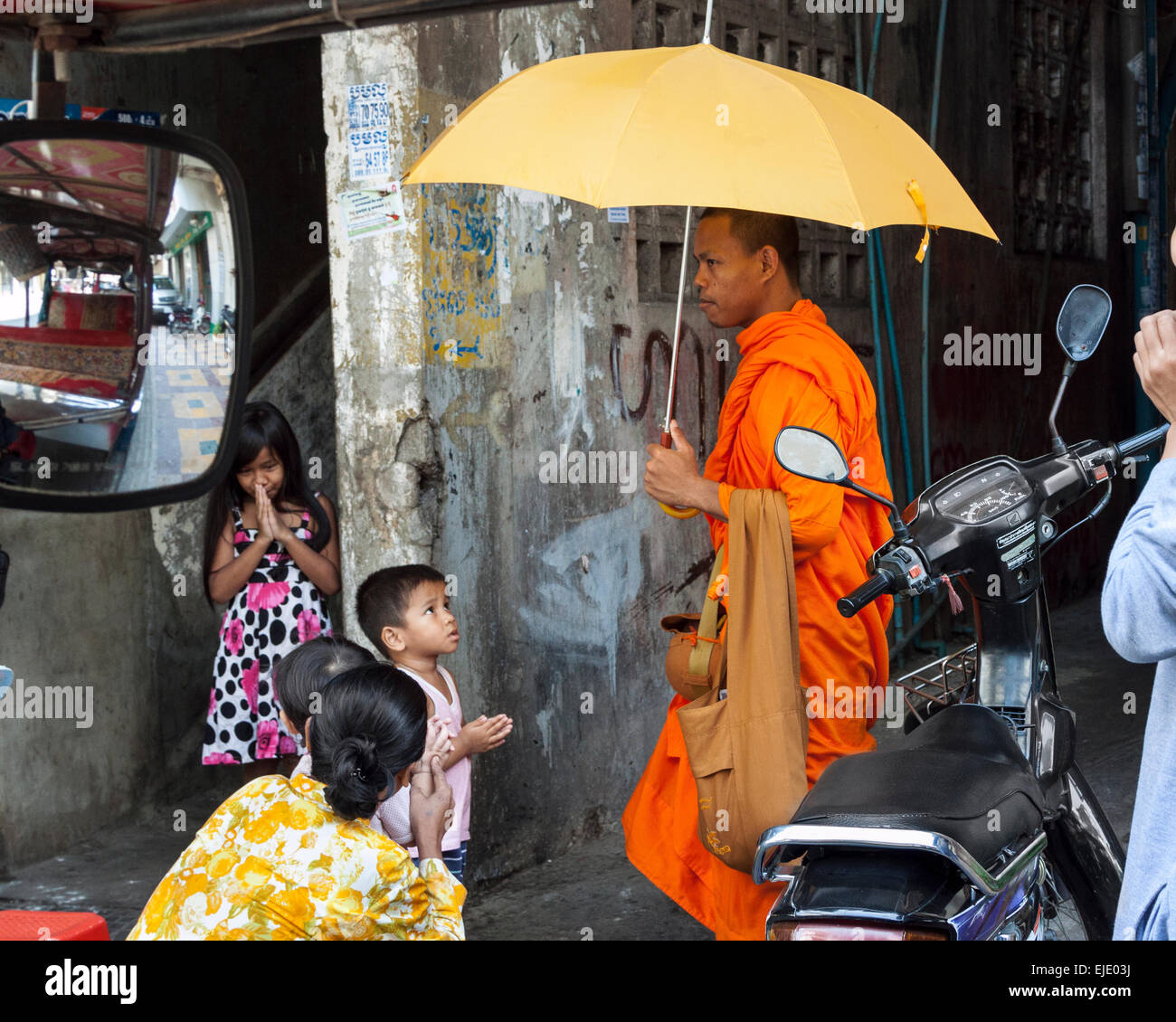 Devotion of Buddhist monk on the street in Phnom Penh, Cambodia. Stock Photo