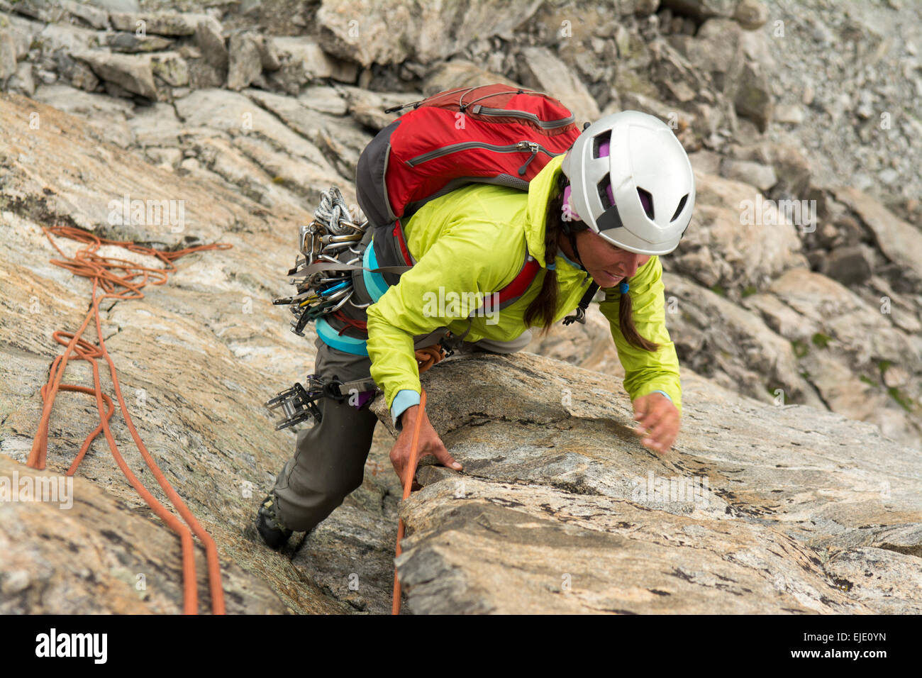 A woman rock climber in Titcomb Basin, WInd River Range, Pinedale, Wyoming. Stock Photo