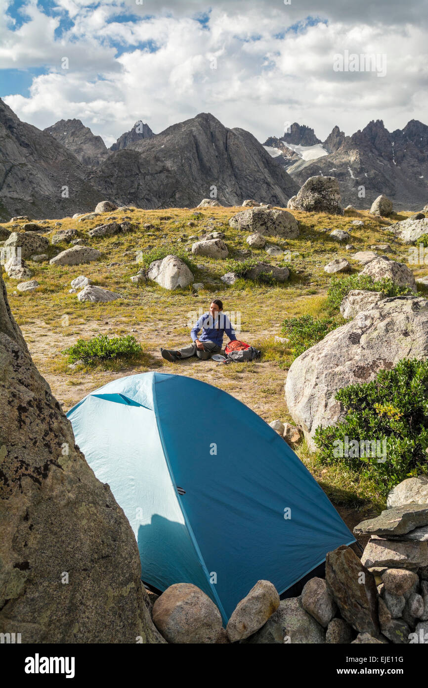 A woman camping in Titcomb Basin, WInd River Range, Pinedale, Wyoming. Stock Photo