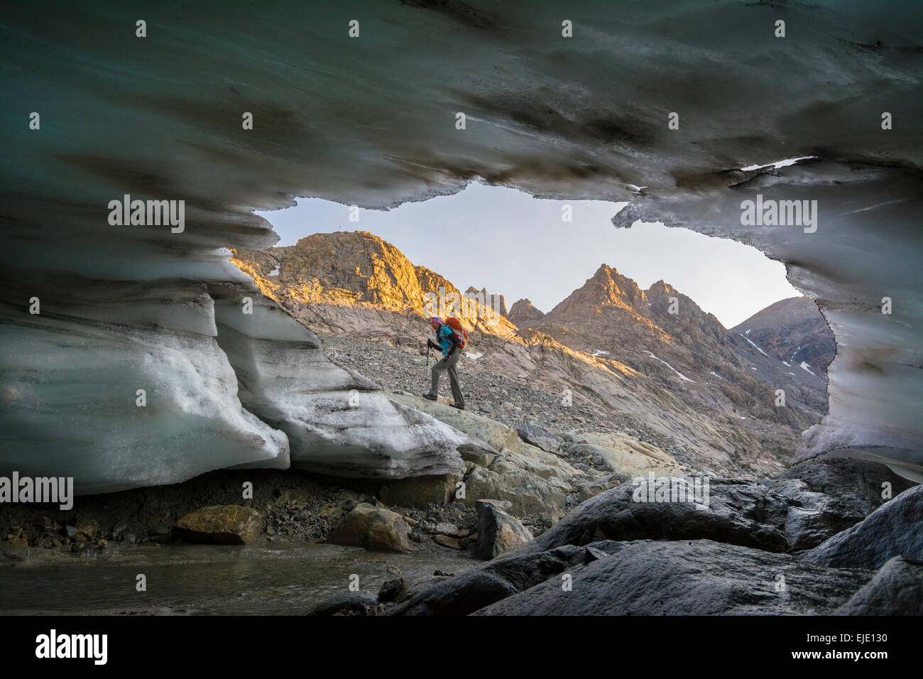 Woman hiker near glacier in Titcomb Basin, Wind River Range, Pinedale, Wyoming. Stock Photo