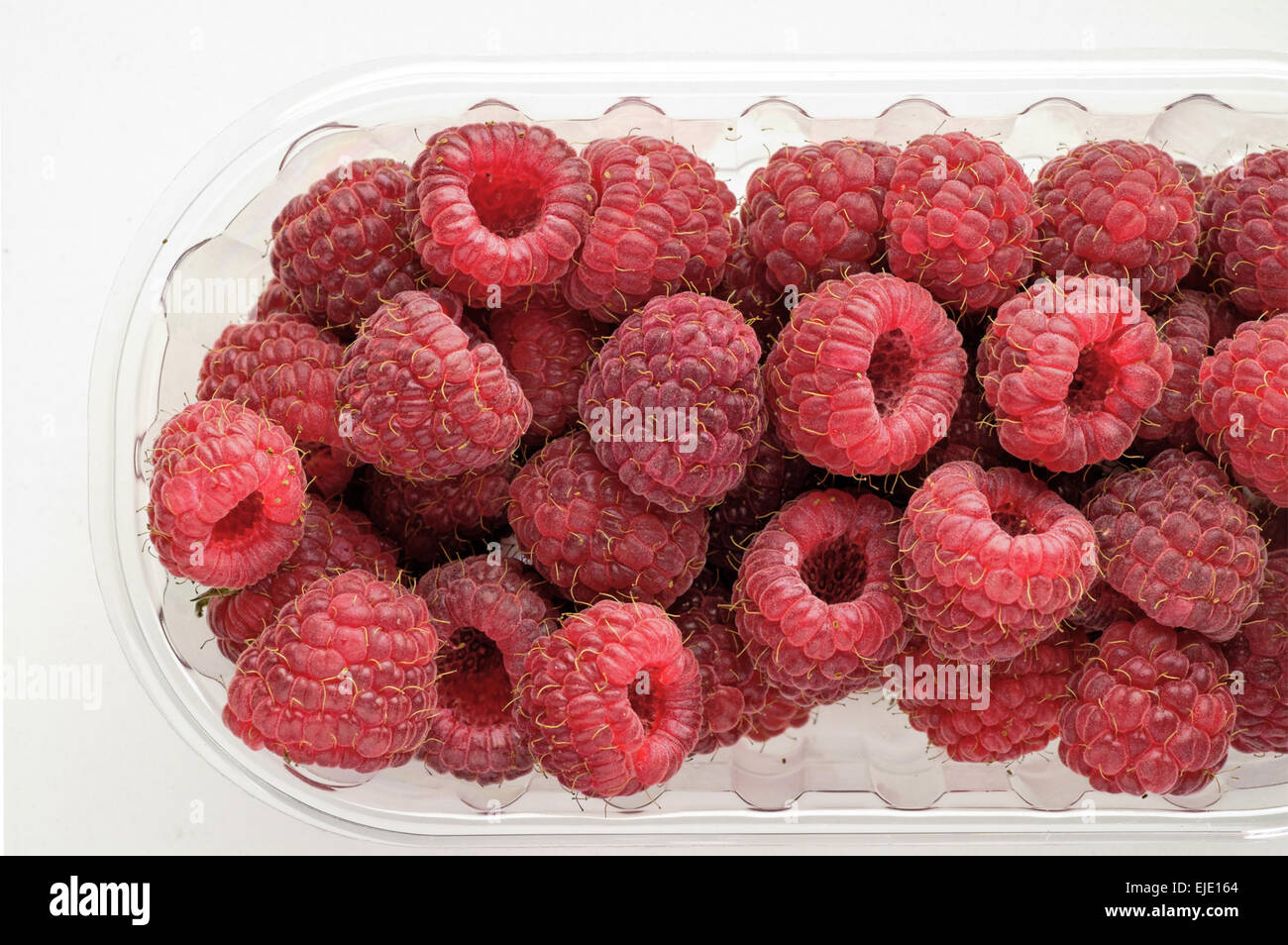 Wild berries raspberries in a glass bowl close-up Stock Photo