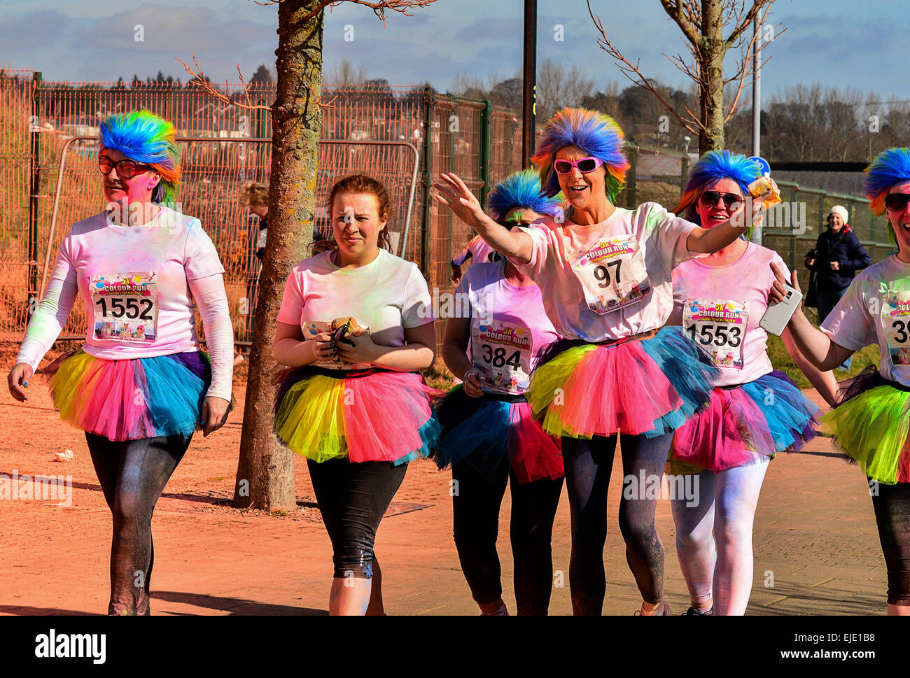 Women in colourful costumes and wigs participate in charity fun run in Londonderry Derry Northern ireland Stock Photo Alamy