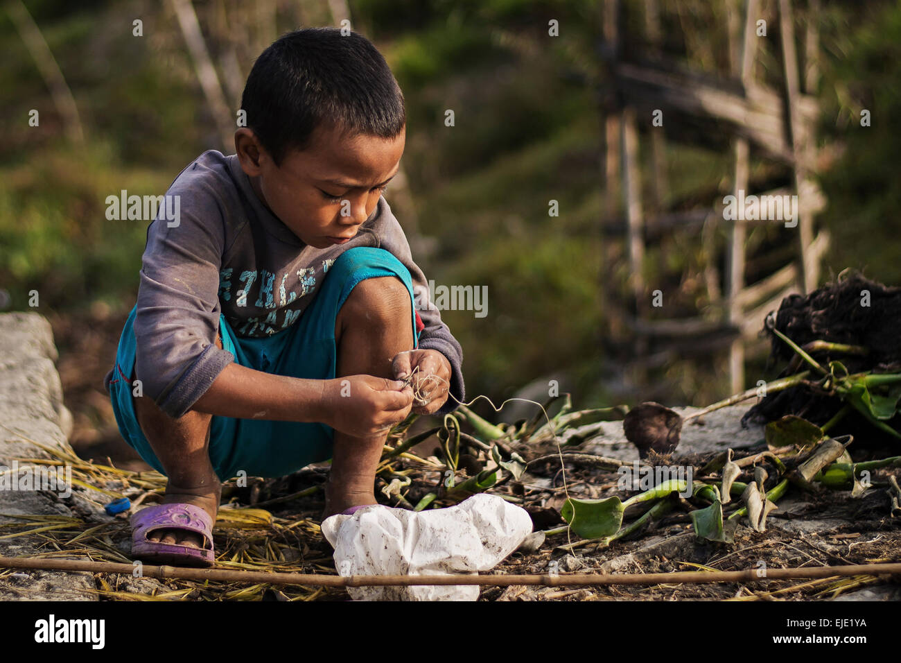 A kid fishing in the morningin Pokhara, Nepal Stock Photo