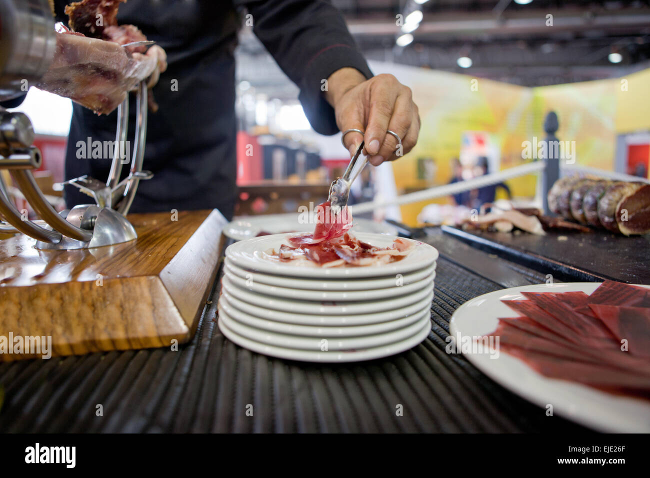 Waiter serving acorn-fed Iberian ham, Spain Stock Photo