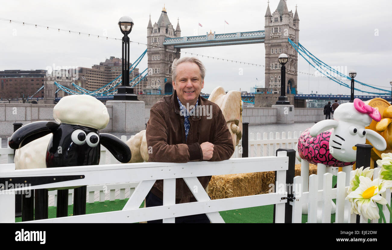 London, UK. 24 March 2015. Animator Nick Park poses with sheep designed by artists and celebrities at the  Shaun in the City London launch. Aardman Animations' 'Shaun the Sheep' are set to be dotted around London from Saturday 28th March to form a special arts trail that will benefit thousands of children in hospitals around the UK. The sculptures have been designed by high profile artists, designers and celebrities including David Gandy, Zayn Malik, Zandra Rhodes and Cath Kidston and will be auctioned after the exhibition finishes on 25th May. Photo: Bettina Strenske Stock Photo