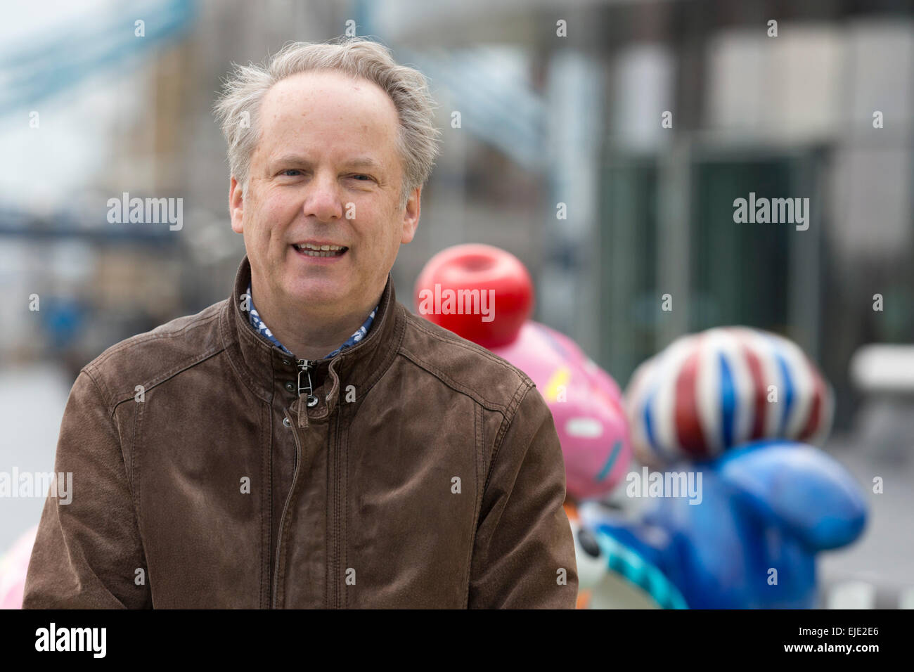 London, UK. 24 March 2015. Animator Nick Park poses with sheep designed by artists and celebrities at the  Shaun in the City London launch. Aardman Animations' 'Shaun the Sheep' are set to be dotted around London from Saturday 28th March to form a special arts trail that will benefit thousands of children in hospitals around the UK. The sculptures have been designed by high profile artists, designers and celebrities including David Gandy, Zayn Malik, Zandra Rhodes and Cath Kidston and will be auctioned after the exhibition finishes on 25th May. Photo: Bettina Strenske Stock Photo