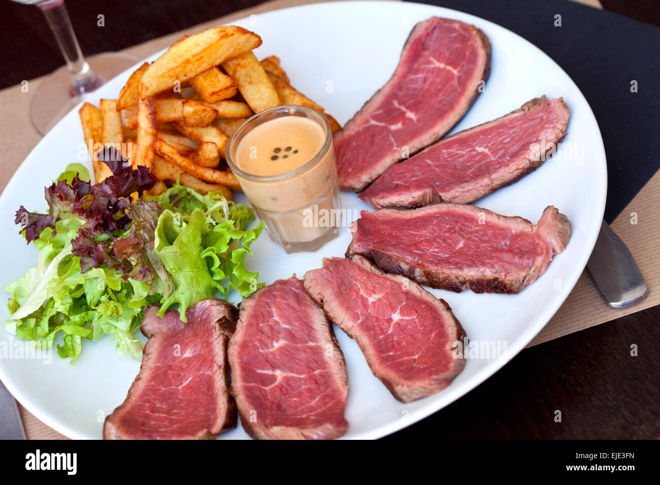 Sliced roast beef, French fries and green salad Stock Photo Alamy