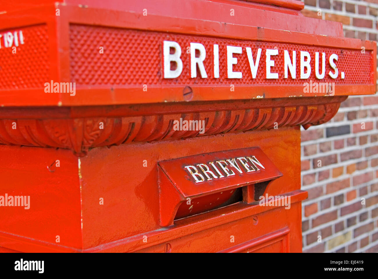 Old red post box at Zaanse Schans north of Amsterdam Stock Photo